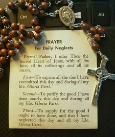 a rosary with a prayer card attached to it