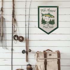 fishing gear hanging on the wall next to a bag and other items in front of it