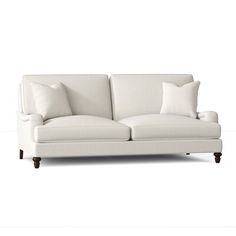 a white couch with two pillows on it