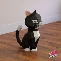 a black and white cat sitting on top of a wooden floor