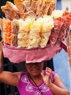 a woman wearing a large basket on her head