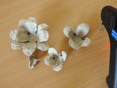 three pieces of paper that have been cut into flowers