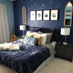 a bedroom with blue walls and gold accents