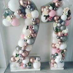 the number twenty seven decorated with balloons and flowers