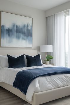 a bedroom with a large painting hanging above the bed