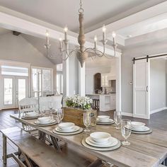 the dining room table is set with place settings