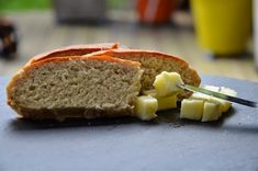 a sliced loaf of bread sitting on top of a cutting board next to a knife