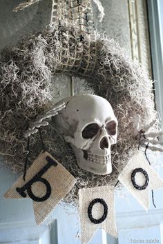 a skeleton head hanging from the side of a door with numbers on it and a sign that says, halloween wreath - halloween decor