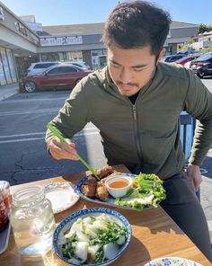 a man sitting at a table with plates of food in front of him and an instagram post about eating