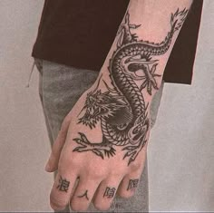 a man with a dragon tattoo on his hand