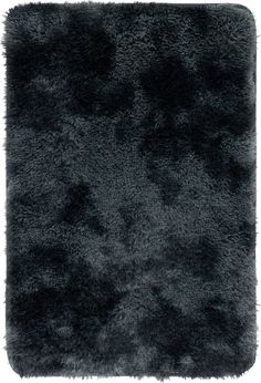 an area rug with black fur on the bottom and grey spots in the middle,