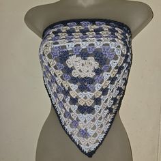 a mannequin wearing a blue and white crocheted shawl