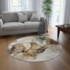 a living room with a white couch and large round rug on the wooden flooring