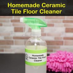 a bottle of homemade tile cleaner sitting on top of a table next to a pink mop