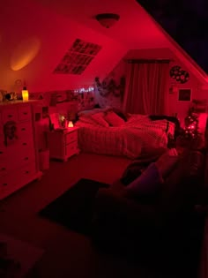 an attic bedroom with red lights on the ceiling