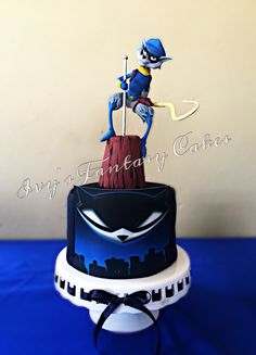 a blue and white cake with an image of a cartoon character on top