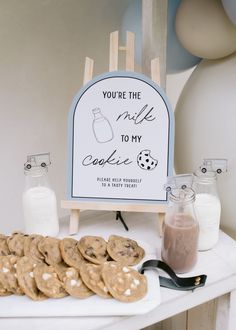 cookies and milk on a table with a sign that says you're the milk to my cookie