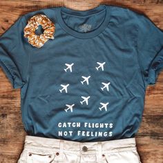 Graphic Tee Shirt In Cadet Blue Color. “Catch Flights Not Feelings” In Front In White, Blank On Back. Size L. Never Worn. New Hut Did Not Come With Tags. Catch Flights Not Feelings, Catch Flights, Cadet Blue, White Blank, Travel Tees, Graphic Tee Shirt, Graphic Tee Shirts, Patterned Shorts, Low Key