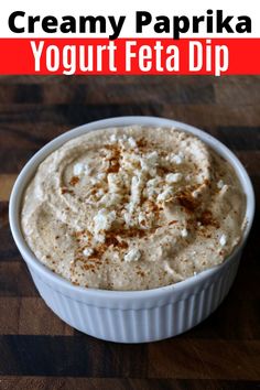 a bowl of creamy paprika yogurt feta dip on a wooden table