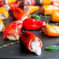 stuffed peppers with cheese and herbs on a baking sheet