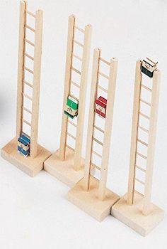 three wooden bookshelves with four different colored books on each shelf in front of a white background