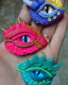 three different colored dragon eyes are in someone's hand