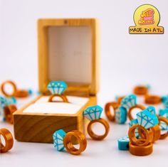 an assortment of rings and ring boxes on a white surface with the box open to show it's contents