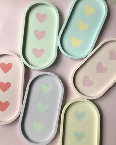 four oval trays with hearts painted on them