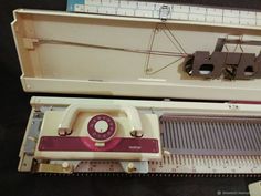 an old sewing machine sitting on top of a piece of paper next to a ruler