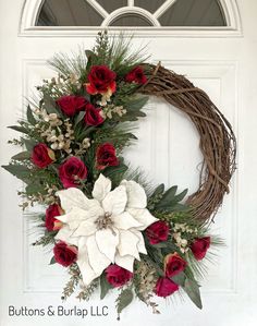 This Christmas wreath has a large velvet poinsettia, deep red roses, different greens and glittered gold stems. Measuring 22” in width and 25” in height, this wreath is ready to ship in 1-3 business days. Wreath Making Ideas Christmas, Christmas Wreaths With Poinsettias, Red And White Christmas Wreaths, Flocked Christmas Wreath Ideas, Christmas Door Wreaths Diy, Christmas Grapevine Wreath Ideas, Poinsettia Wreath Diy, Christmas Wreath White, Scrapbook Recipe