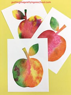 three apples cut out from paper on top of a yellow background with text overlay that says, apple crafts for kids