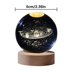 an image of a black and gold ball with stars on the outside, in front of a white background