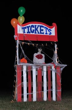 a circus ticket booth with balloons and lights