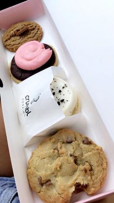 an open box with assorted cookies in it