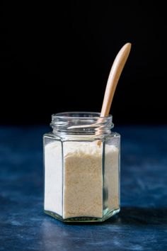 a jar filled with sugar and a wooden spoon