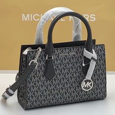 Michael Kors Sheila Small Faux Saffiano Leather Satchel Black/Silver ~Wt New With The Tag Authentic Day Or Night, The Sheila Satchel Is Always Chic And Ready To Go. This Faux Saffiano Leather Bag Is Designed In A Structured Silhouette With A Zip Closure For Added Security And A Slip Pocket Inside For Your Cardholder Or Phone. Carry It By The Elegant Top Handle, Or Attach The Included Shoulder Strap To Wear It Crossbody. Satchel Faux Leather 88.92% Coated Canvas/11.08% Polyester Silver-Tone Hardw Crossover Bags, Pink Crossbody Bag, Crossbody Satchel, Michael Kors Crossbody Bag, Cute Purses, Black Leather Bags, Mini Crossbody Bag, Purses Michael Kors, Black Cross Body Bag