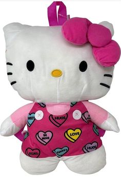 a hello kitty stuffed animal is wearing a pink shirt with hearts on it's chest