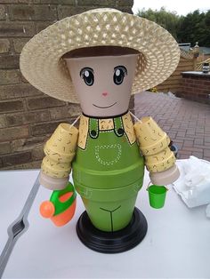 a toy with a hat on top of it sitting next to a fork and knife