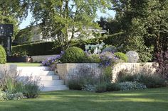 an outdoor garden with stone walls and landscaping