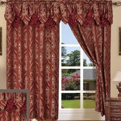 a living room scene with focus on the curtains and window curtain valance, which is decorated in red damask