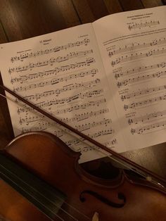 an old violin and sheet music on a table