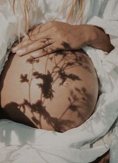 a pregnant woman's shadow cast on her stomach