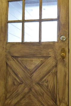 the front door is made out of wood and has two glass panels on each side