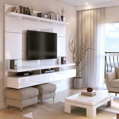 a living room filled with furniture and a flat screen tv on top of a wall