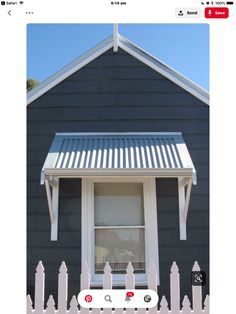 a black house with a white picket fence