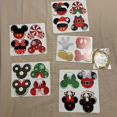 four mickey mouse stickers are on a sheet with foil and some candy canes