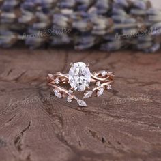 a close up of a ring on top of a table with flowers and stones in the background