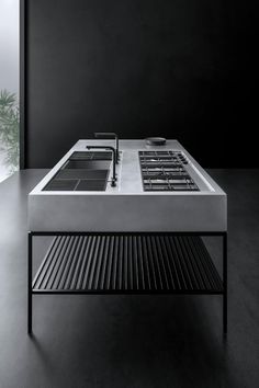 a modern coffee table with black and white decor in the middle, against a dark background