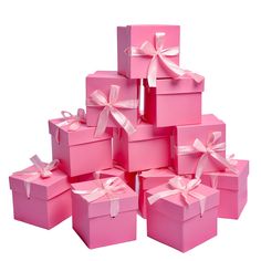 a stack of pink boxes with bows on them