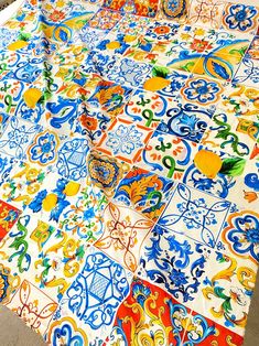 an image of a table cloth with many designs on it